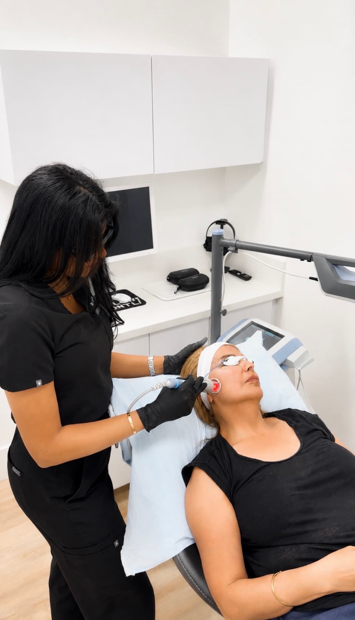 EMVITAL TMJ laser therapy being applied to a patient's jaw at GLOW DNTL